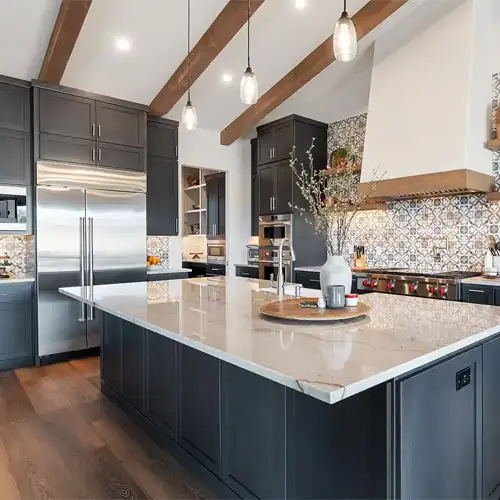 Sydney kitchen renovation – WizBuilt modern Sydney kitchen renovation with dark cabinetry, stone island bench and timber ceiling beams