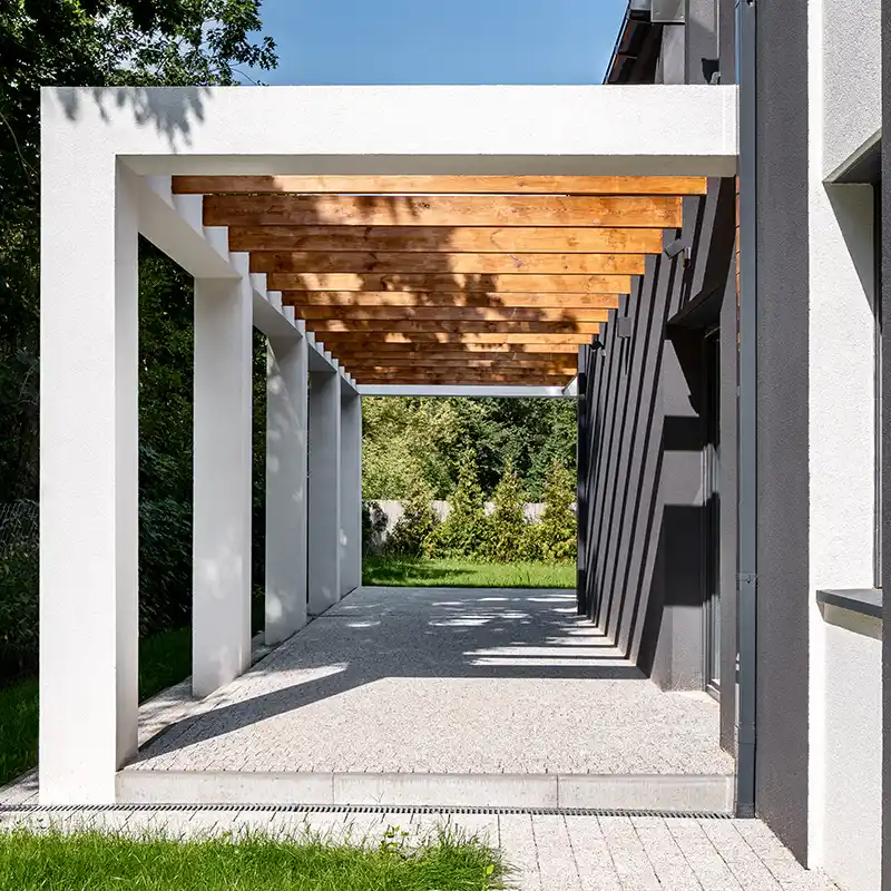 Contemporary exterior pergola with timber beams and rendered posts